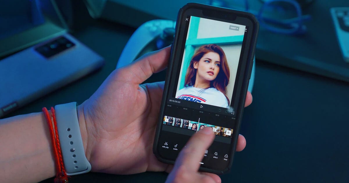 Person editing a video on a smartphone screen.
