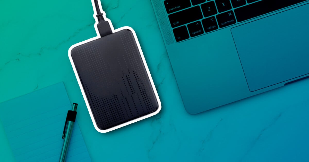 External hard drive connected beside a laptop on a desk.