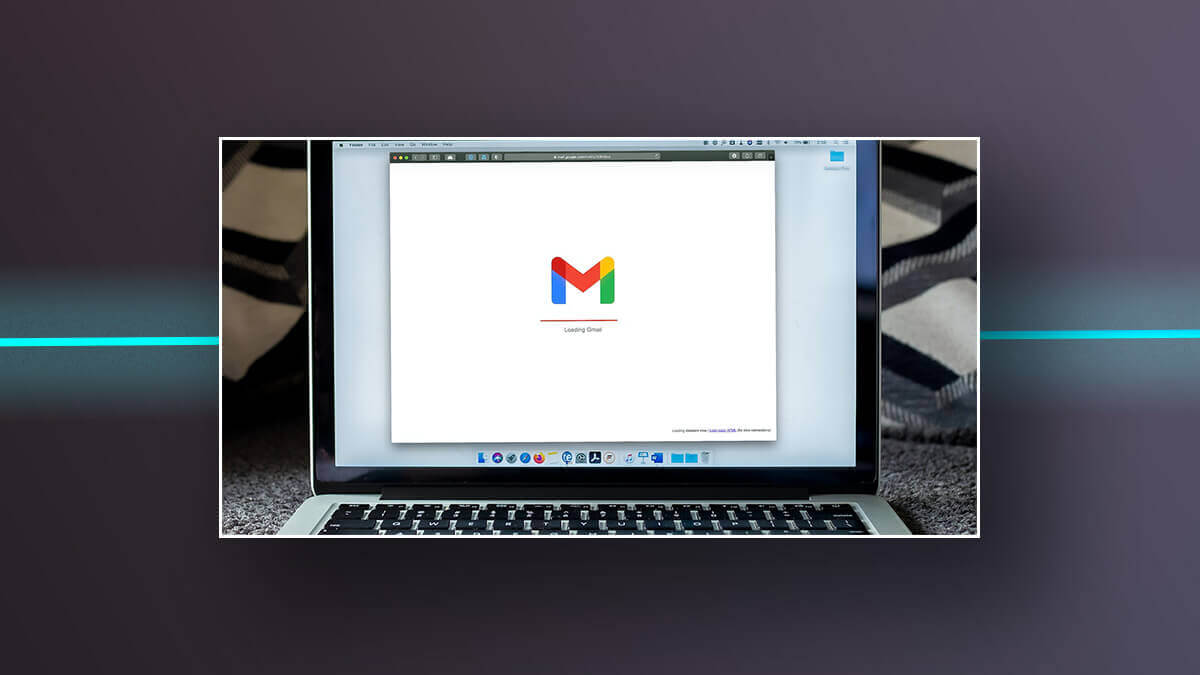 Laptop screen showing Gmail loading.