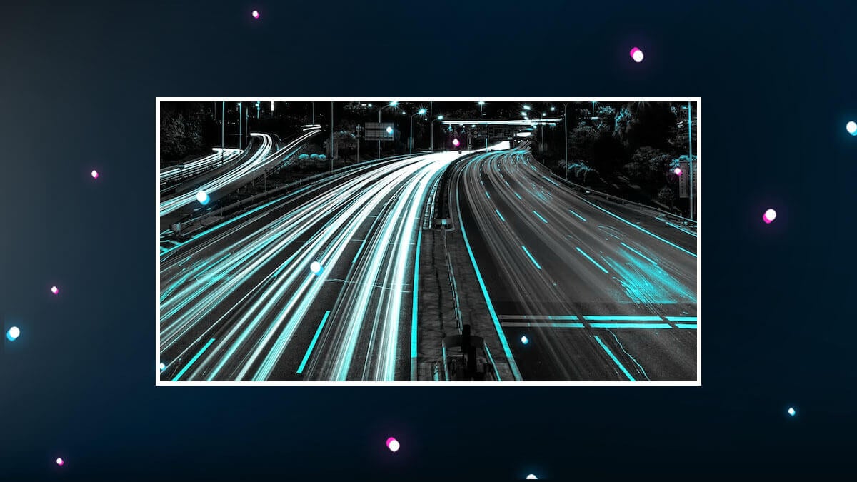 Night highway with glowing light trails, symbolizing speed and data flow.