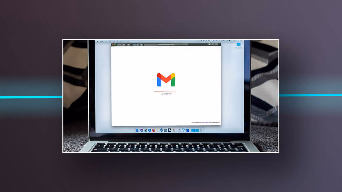 Laptop screen showing Gmail loading.