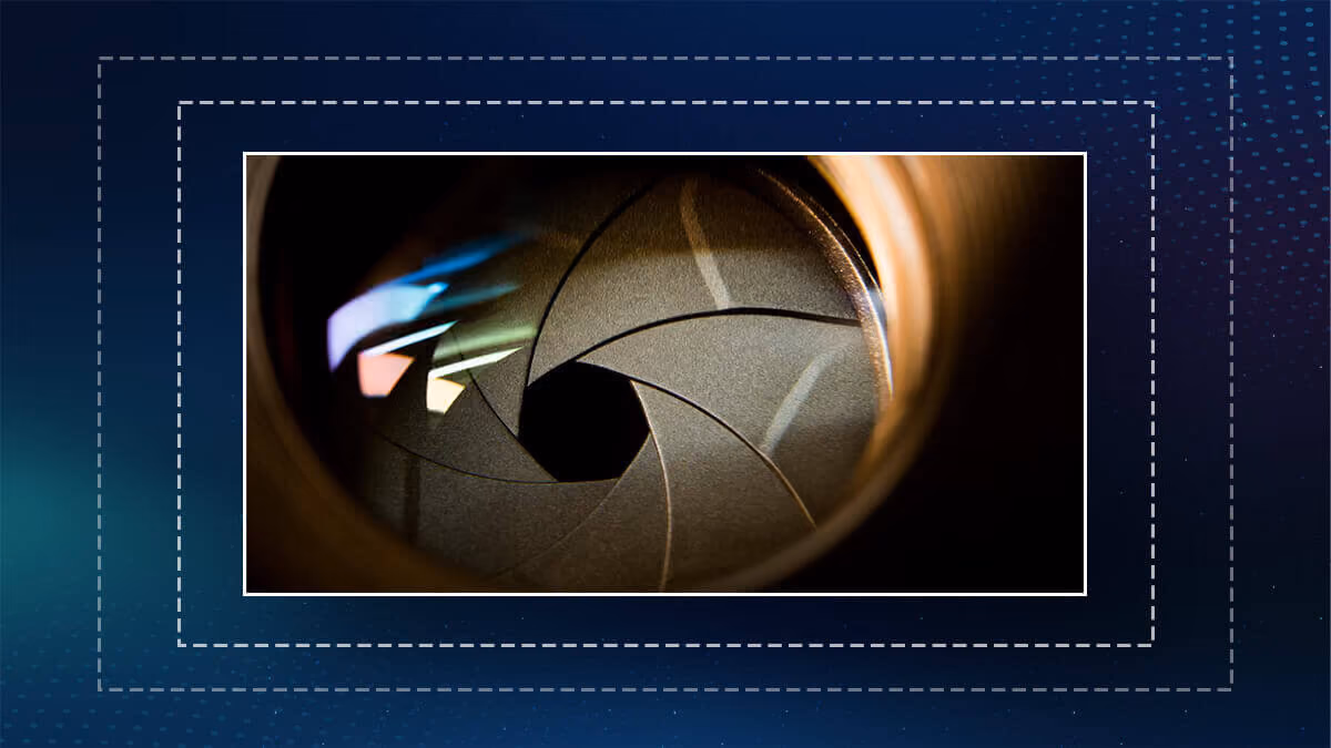 Close-up of a camera lens aperture with light reflections.