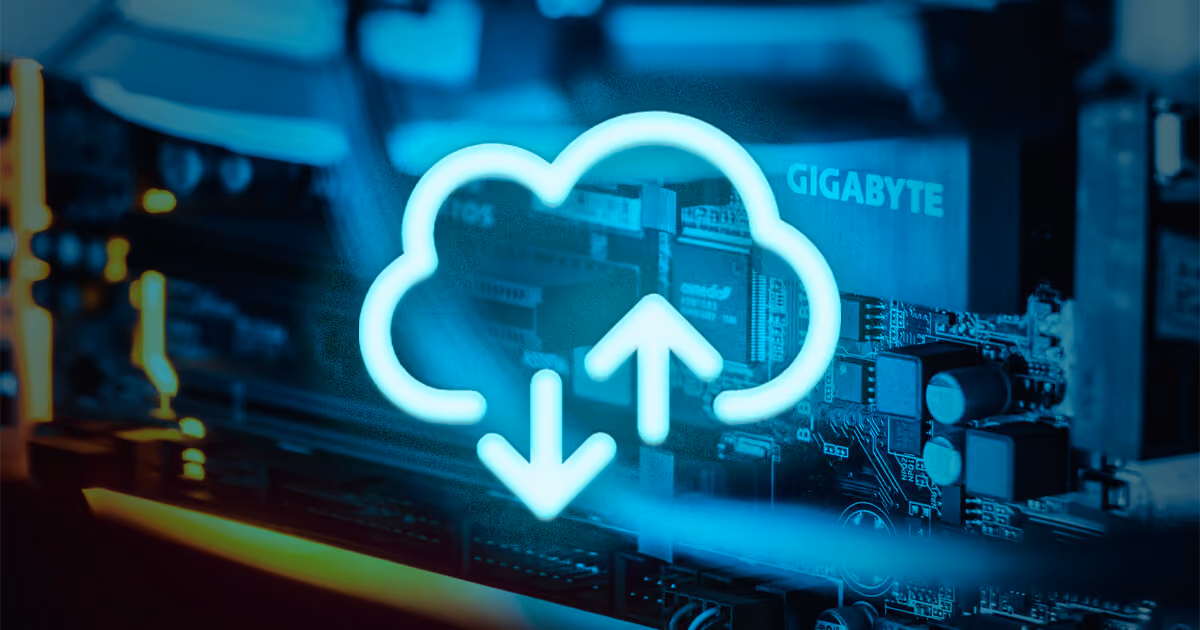 Glowing cloud upload/download icon over computer hardware.