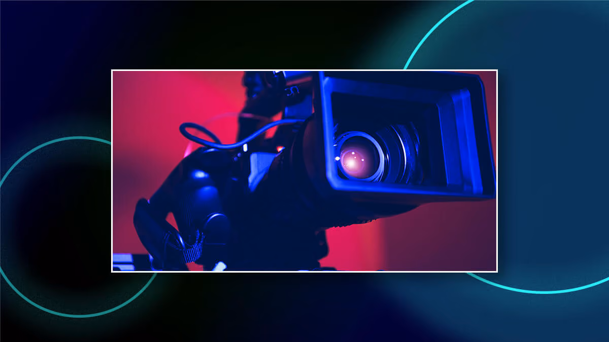 Close-up of a video camera lens lit in blue and pink, framed over a dark graphic background.
