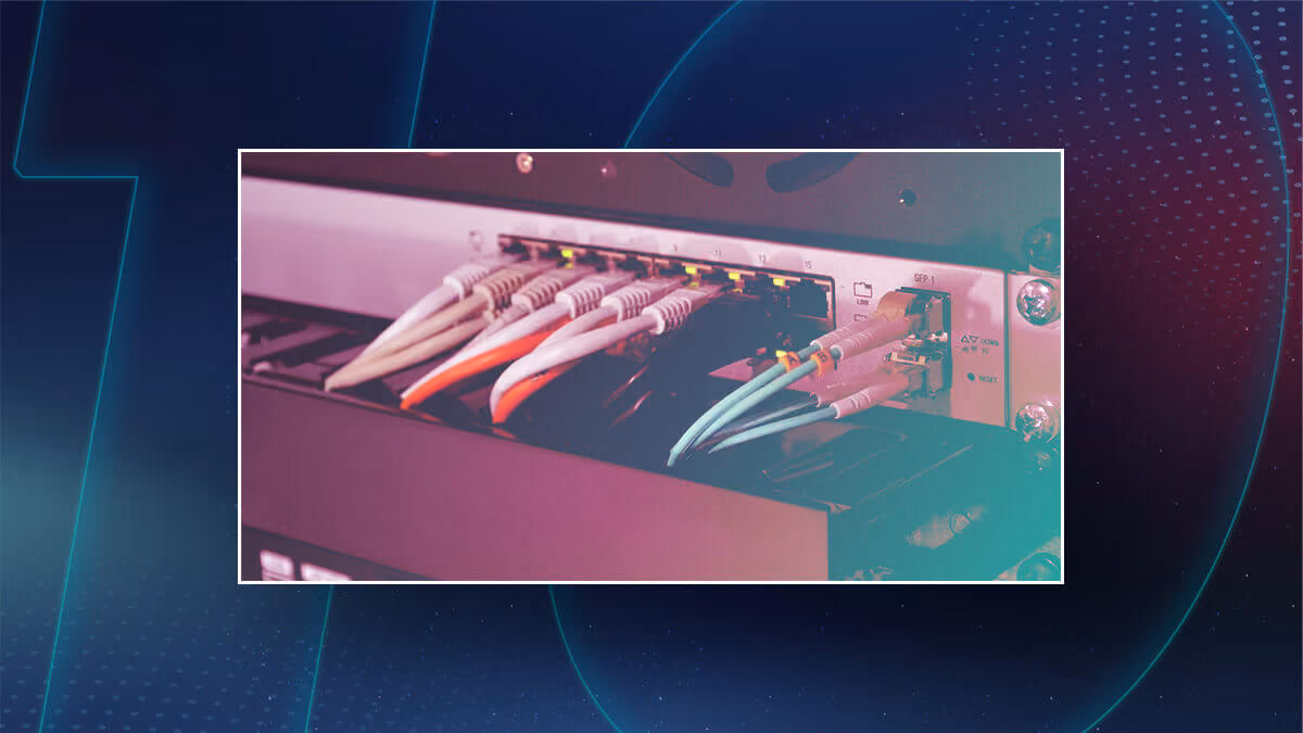 A close-up of Ethernet cables plugged into a network switch, displayed within a dark blue, futuristic digital-themed background with glowing lines and dots.